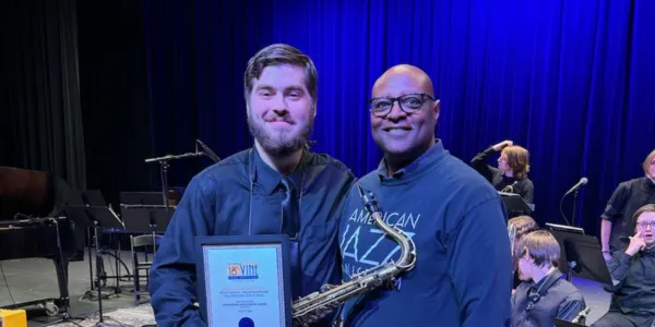 Student saxophonist receiving an award at the Gem Theatre
