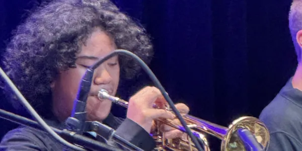 Student trumpet player performing at the festival